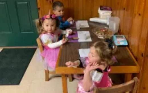 a group of children sitting at a table