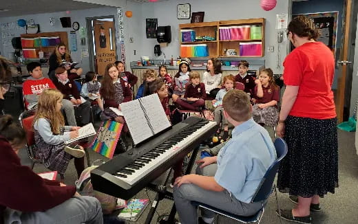 a group of people playing piano