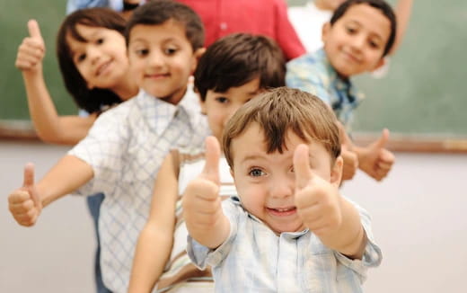 a group of children making hand gestures