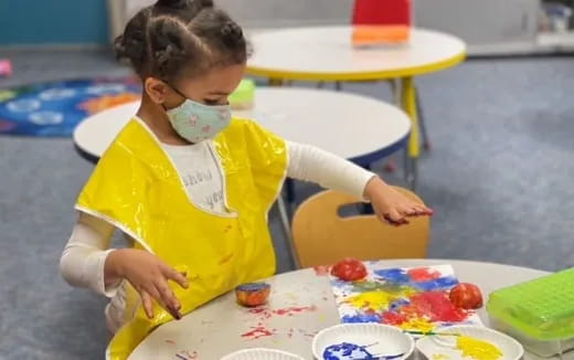 a child painting on a table