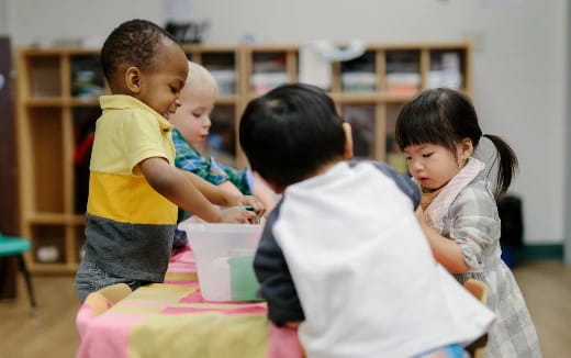 a group of children playing with a toy