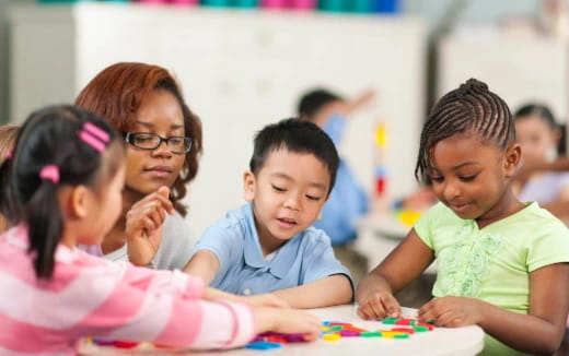 a group of children sitting at a table