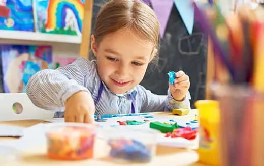 a child painting on a table