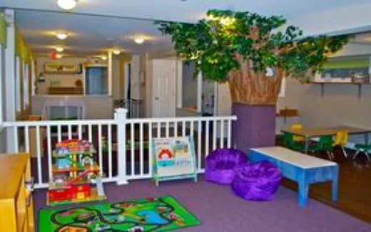 a room with a white railing and a tree in the middle