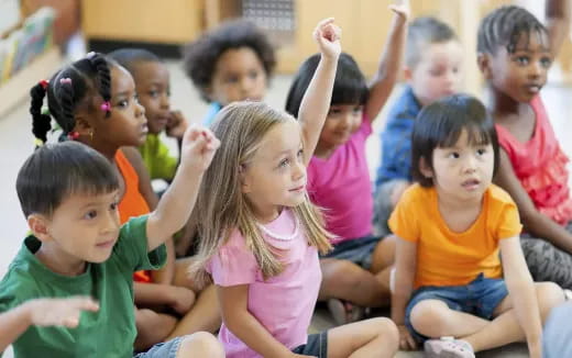a group of children sitting in a classroom