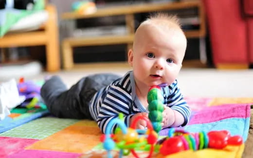 a baby lying on the floor