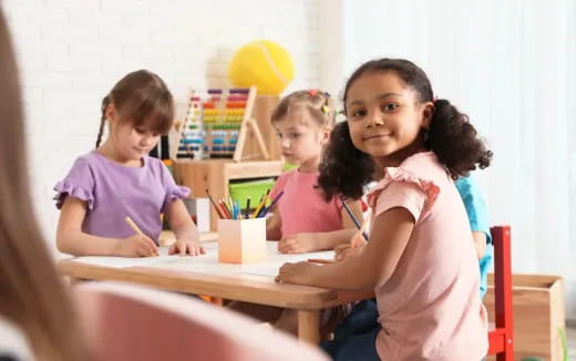 a group of children sitting at a table