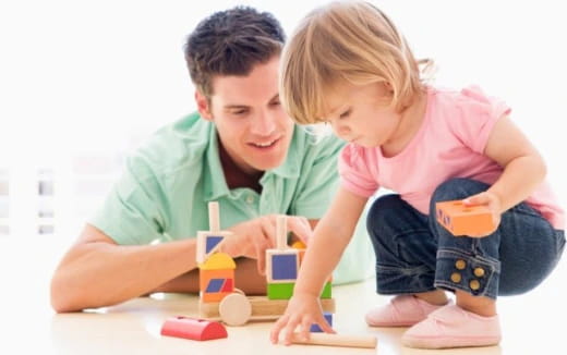 a boy and girl playing with toys