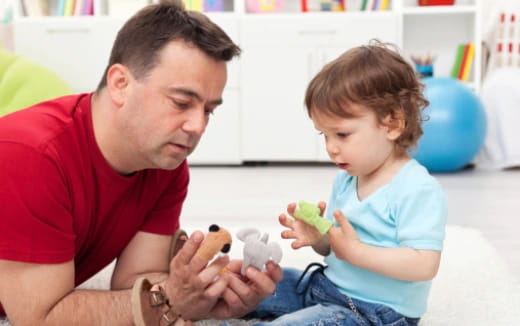 a man and a child playing with toys