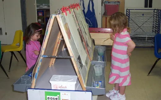a couple of girls playing with a toy