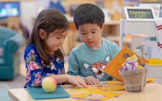 a person and a child looking at a book