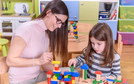 a woman and a child playing with toys