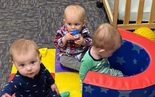 a group of boys sitting on a blanket