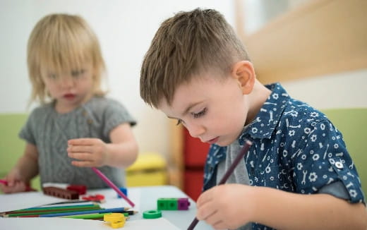 a boy and girl playing with toys