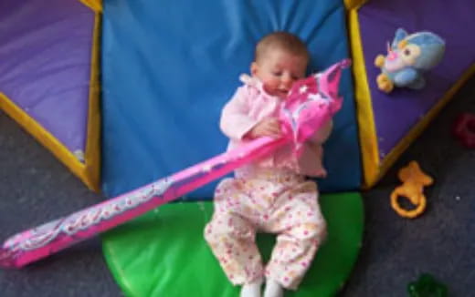 a baby sitting on a green chair