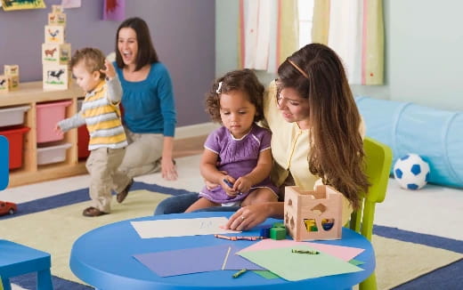 a person and children playing with toys
