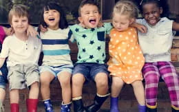 a group of children sitting on a bench