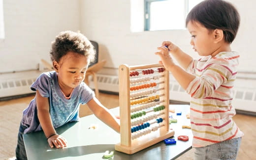 a couple of kids playing with a building