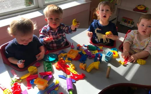 a group of children playing with toys