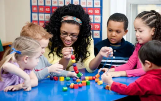 a person and several children playing with toys