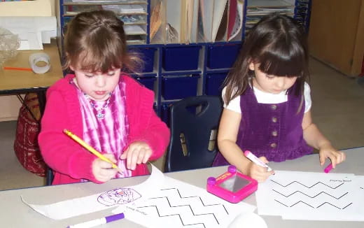 a couple of young girls painting