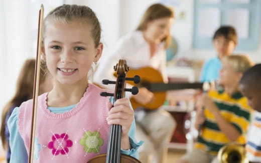a young girl playing a violin