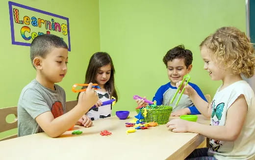 a group of children sitting at a table