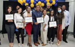 a group of people holding certificates