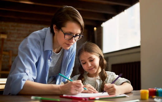 a person and a girl looking at a book