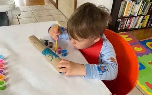 a child painting on a table