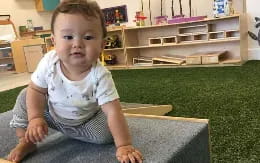 a baby sitting on a couch