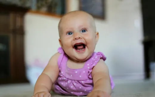 a baby with a pink dress