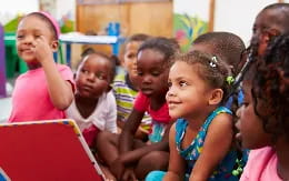 a group of children sitting in a classroom