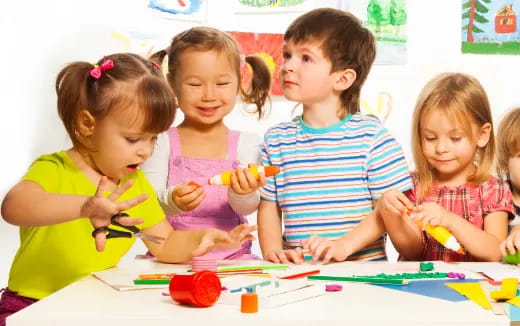 a group of children sitting at a table