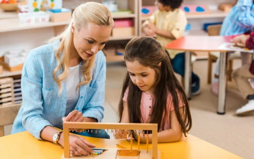 a woman and a girl working on a project