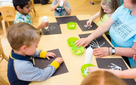 a group of children sitting at a table