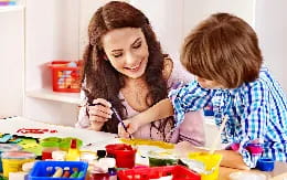 a person and a child painting