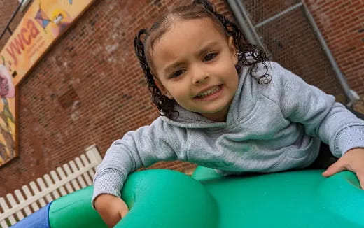 a child in a green plastic tub
