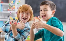 a boy and girl holding up their fingers