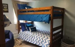 a bunk bed with a blue blanket