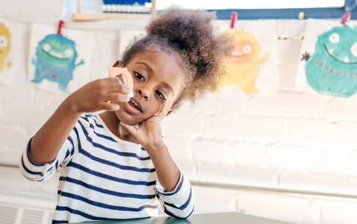 a child holding a bottle to their mouth