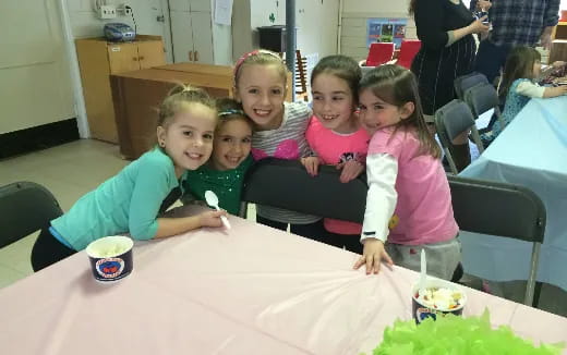 a group of children sitting at a table