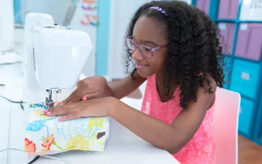a person using a sewing machine