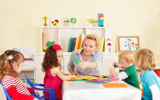 a group of children sitting around a table