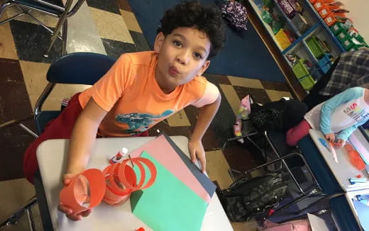 a boy sitting at a table