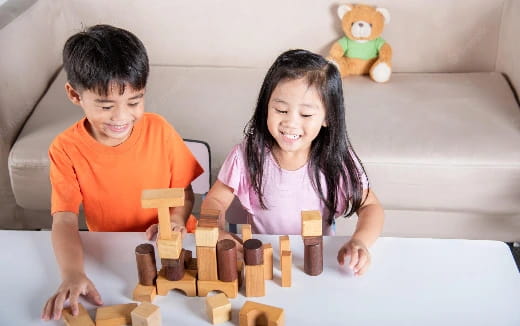 a boy and girl playing chess