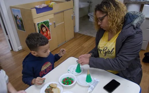 a person and a child eating at a table