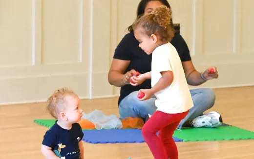 a person and a child playing on a mat