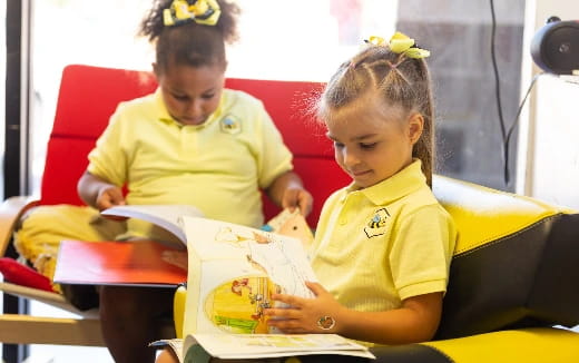 a couple of young girls reading books