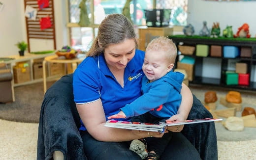 a person reading a book to a baby
